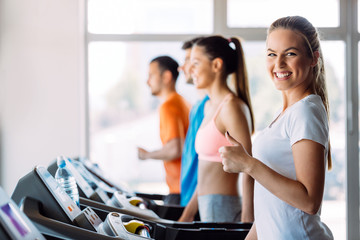 Group of friends exercising on treadmill machine