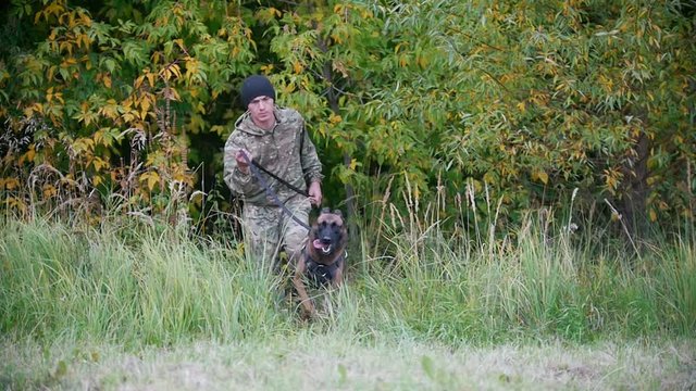 Trainer and his dog running towards the camera