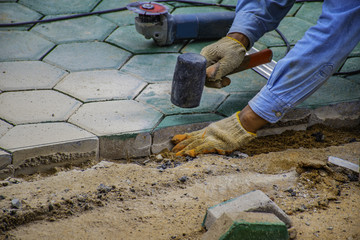 The man paving green hexagon concrete block.