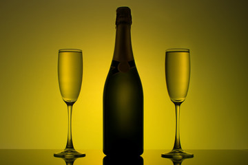 a bottle of champagne with two glasses