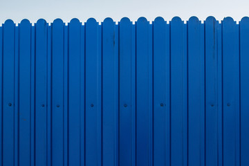 Texture metallic blue fence in the city. Construction works.