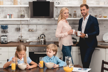 casual young family having breakfast together at kitchen