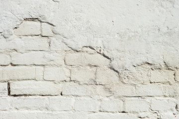 Texture of a white brick wall with a stucco. Close-up. Background