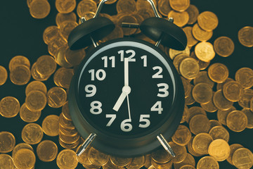 Alarm clock and coins stacks on working table, time for savings money concept, banking and business concept
