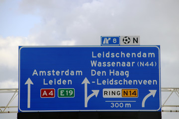 Directions signs above motorway A4 at a split at Prins Clausplein crossing with also route to regional road N14 in the Netherlands