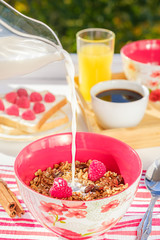 still life: granola with raspberries, toast with curd cheese and raspberries, coffee and orange juice