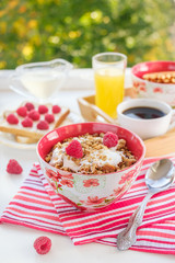 still life: granola with raspberries, toast with curd cheese and raspberries, coffee and orange juice