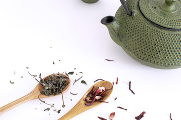 Tea ceremony Iron teapot Cups Wooden spoon Tea leaves Dried hibiscus White background Copy space Flat lay