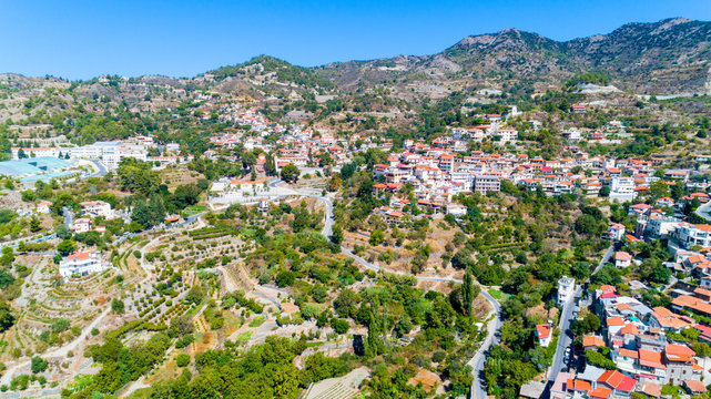 Aerial view of Agros village settlement on mountain Troodos, Limassol district, Cyprus. Bird's eye view of traditional houses with ceramic tile roof, church, countryside and rural landscape from above