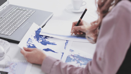 young female accountant checking financial statement. business concept