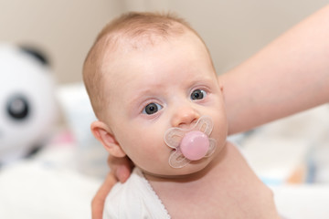 Portrait of baby with pacifier