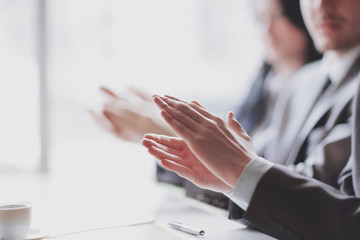 Close-up of business people clapping hands. Business seminar concept