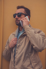 Attractive man using cellphone in the European city.