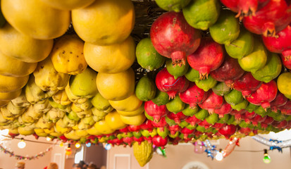 Fototapeta na wymiar Festively fruits decorated ceiling in Samaritans house during Sukkot holiday