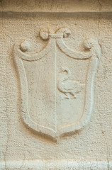 Old heraldic emblem with a swan relief on a Venice wall