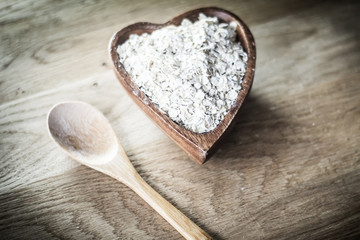 closeup.muesli and wooden spoon on a wooden table.