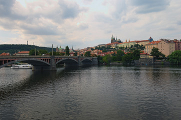 Fototapeta na wymiar Scenic view of historical center of Prague, Manes Bridge and Vltava river at cloudy summer day. Buildings, cathedrals and landmarks of old town, Prague, Czech Republic