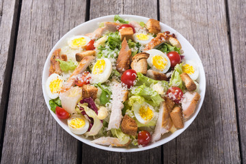 Salad ceasar with chicken , eggs and tomatoes