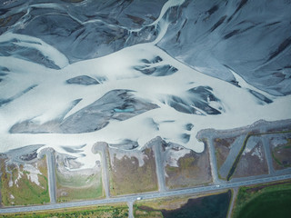 Long snow hills in Iceland with road and cars top view
