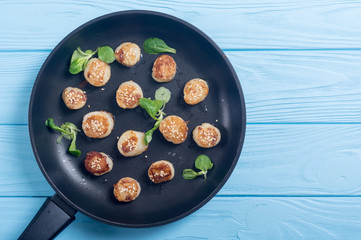 Fried scallops with lemon and salad