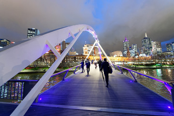 Naklejka premium City skyscrapers and Yarra river at night from Southbank Footbridge, Melbourne