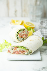 Salmon wraps with lettuce, cucumber and lemon