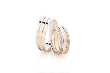 Pair of pink gold and white gold wedding rings isolated on white background