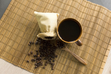 Coffee and coffee beans on wooden floor