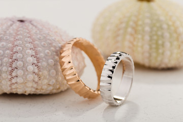 Pair of pink gold and white gold textured wedding rings