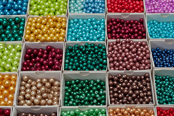 close up multi colored beads heap in box