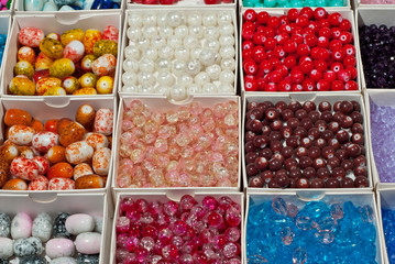 close up multi colored beads heap in box