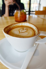 Hot coffee on wooden table