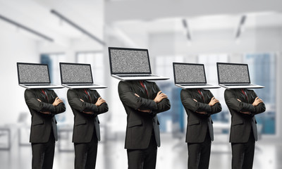 Businessmen with laptops instead of head.