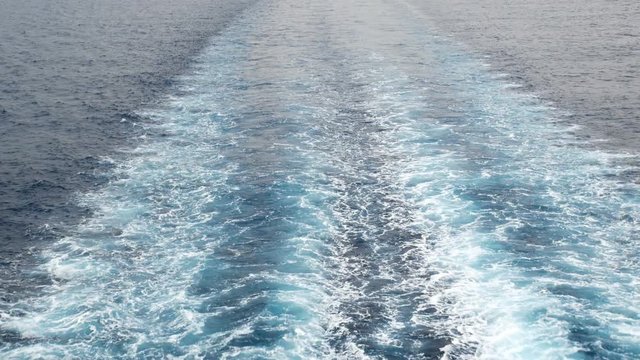 Large ferry ship trail on water surface