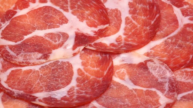 UHD closeup shot of the delicious thin sliced Coppa or Capicola ham on a turntable