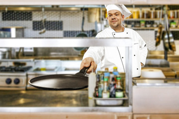 Cook chef and kitchen interior 