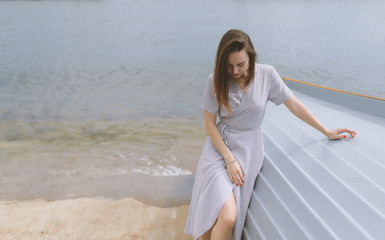 Young woman sitting down on the boat.