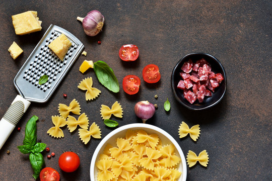 Food frame. Ingredients for pasta - cherry tomatoes, garlic, basil, Parmesan, top view.