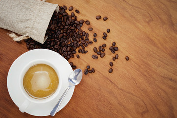 top view coffee cup and beans on wood background