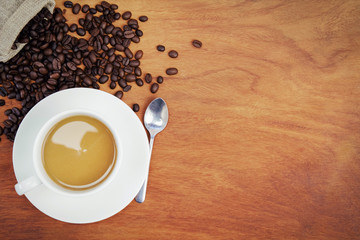 top view coffee cup and beans on wood background