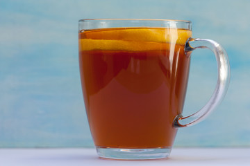 Delicious tea with a lemon on blue and white background.