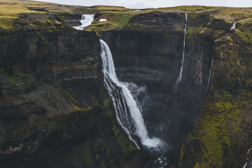 aerial view of dramatic Haifoss waterfall and rocky cliff, Iceland