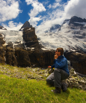 Tourist watching a mountain landscape with glaciers and peaks nearby resort of Kandersteg, Switzerland