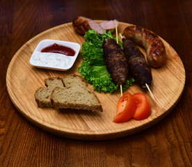 Kebab cooked meat dishes on wooden board. Serving kebab of Middle Eastern cuisine in restaurant. The hot food