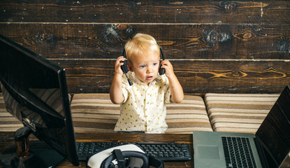 Cute baby operator in headset with laptop. Operator online. Providing best support