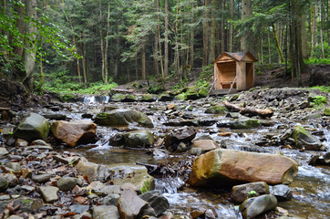 Rocky mountain river with gazebo in the forest
