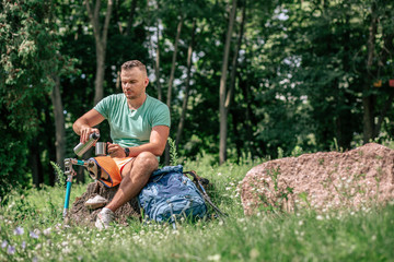 Nice young man with prosthesis resting in harmony with nature