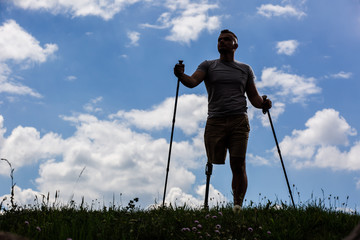 Full length of a disabled man holding Nordic walking sticks
