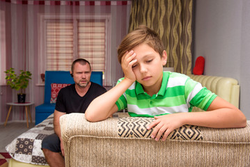 Family conflict, the problems of the father and son of a teenager in the room.