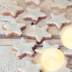 cinnamon stars at wooden background with bokeh,square format
